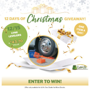 Close-up of a vehicle tire resting on orange Lynx levelers, part of a Christmas giveaway promotion.