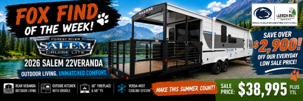 2026 Salem 22Veranda travel trailer with rear outdoor living veranda and outside kitchen in a scenic mountain setting.
